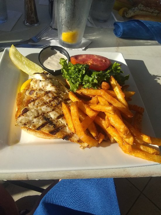 Lighthouse Waterfront Restaurant signature dishes Lighthouse Lobster Bisque, Macadamia Crusted Grouper, Coconut Shrimp, Fish and Chips